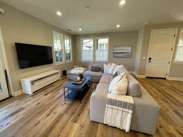 Santa Barbara apartment for rent - A living room with a grey couch and a flat screen TV.