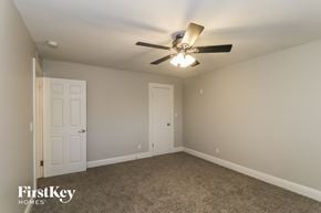 Phoenix house for rent - a bedroom with a ceiling fan and a door