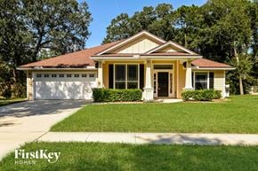 Jacksonville house for rent - a small yellow house with a lawn and a driveway