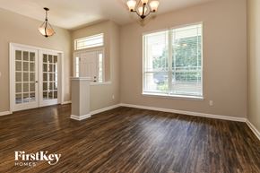 Jacksonville house for rent - the living room of a home with a hardwood floor and a window