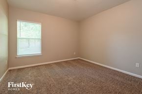 Jacksonville house for rent - the upstairs bedroom has a carpeted floor and a window