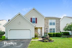 Hilliard house for rent - a beige and white house with a white garage door