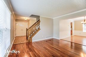 Hilliard house for rent - the living room and entryway of a house with wood floors and a staircase