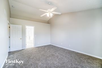 Hilliard house for rent - a spacious living room with carpet and a ceiling fan