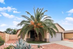 Glendale house for rent - A palm tree stands in front of a house with a sign that says "Firstkey Homes".