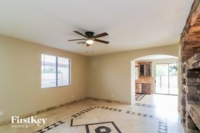 Glendale house for rent - A spacious room with a ceiling fan and a checkerboard floor.