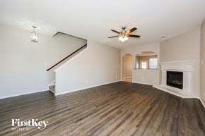 Dallas house for rent - A spacious living room with a fireplace and a staircase.