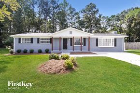 Powder Springs house for rent - a white house with a lawn and a driveway