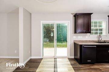Lexington house for rent - A kitchen with a black dishwasher and brown cabinets.