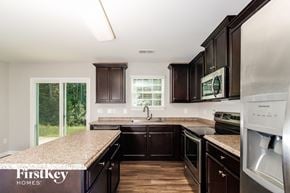 Lexington house for rent - A kitchen with dark wood cabinets and stainless steel appliances.
