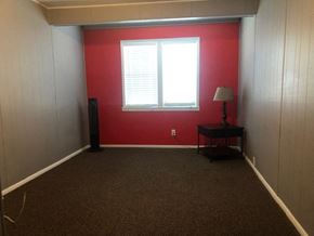 Snyder house for rent - a room with a red wall and a window