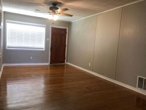 Snyder house for rent - a living room with a wooden floor and a ceiling fan