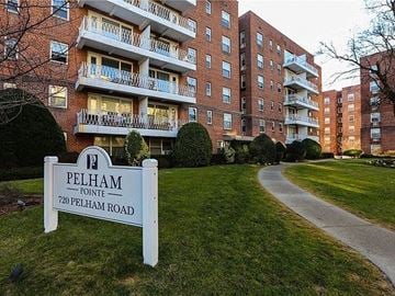New Rochelle apartment for rent - a sign in the grass in front of an apartment building