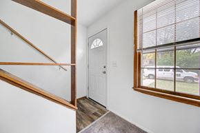 Bloomington apartment for rent - the entrance to a home with a large window and a white door