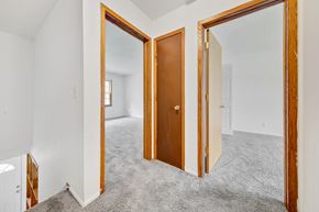 Bloomington apartment for rent - a bedroom with three doors and a carpeted floor