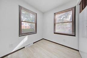 Brooklyn Center apartment for rent - the living room of a house with two windows and wood flooring