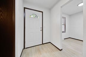 Brooklyn Center apartment for rent - an empty living room with a white door and a window