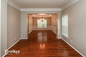 Huntersville house for rent - an empty dining room with wood floors and a chandelier