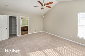 Huntersville house for rent - a living room with carpet and a ceiling fan