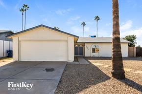 Mesa house for rent - a white house with palm trees and a driveway
