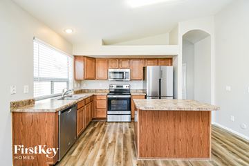 San Tan Valley house for rent - A kitchen with wooden cabinets and a countertop.
