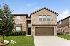 Fort Worth house for rent - a large brick house with a garage door
