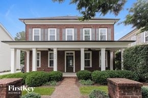Charlotte house for rent - a brick house with white pillars and a walkway