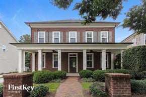 Charlotte house for rent - a brick house with white pillars and a walkway