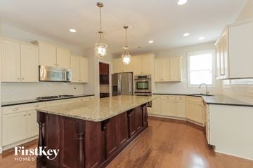 Charlotte house for rent - a kitchen with white cabinets and a marble counter top