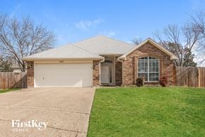 Arlington house for rent - the front of a brick house with a lawn and a white garage door