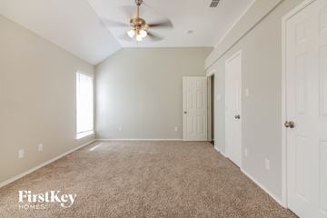 Arlington house for rent - a spacious living room with carpet and a ceiling fan