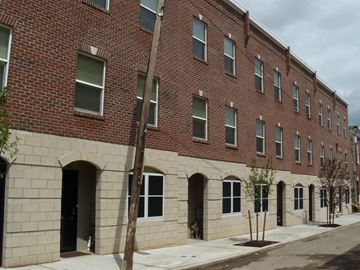 Philadelphia apartment for rent - the side of a brick building with windows and a sidewalk