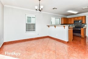 Tucson house for rent - a kitchen with a counter top and a stove and a sink