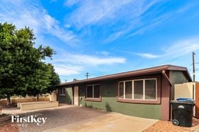 Mesa house for rent - an old green house with a tree and a blue sky