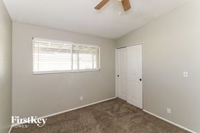 Mesa house for rent - a bedroom with carpet and a window and a door
