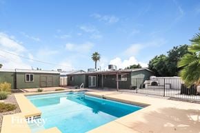 Mesa house for rent - a swimming pool in front of a house with a fence
