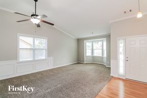 Hiram house for rent - an empty living room with a ceiling fan and a window