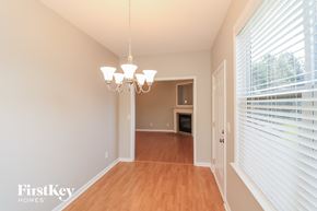 Hiram house for rent - a dining room with wood flooring and a large window