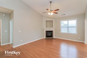 Hiram house for rent - a living room with a fireplace and a ceiling fan