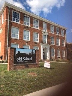 Newark apartment for rent - an old school sign in front of a brick building