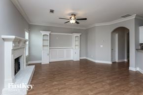 Lawrenceville house for rent - a living room with a fireplace and a ceiling fan