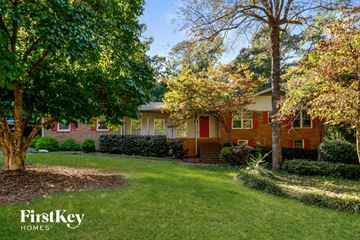 Snellville house for rent - a red brick house with trees in front of it