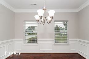High Pt house for rent - a dining room with two windows and a chandelier