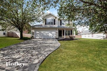 Monroe house for rent - a driveway leading to a house with a garage door