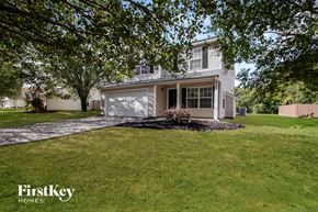 Monroe house for rent - a white house with a lawn and a driveway