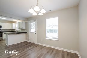 Monroe house for rent - a living room with a kitchen and a chandelier