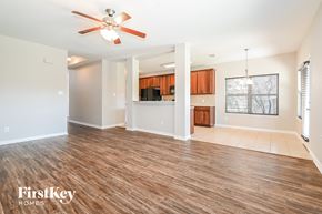 Royse City house for rent - A spacious room with wooden flooring and a ceiling fan.
