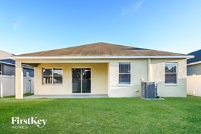 Riverview house for rent - a house with a grass yard and a trash can