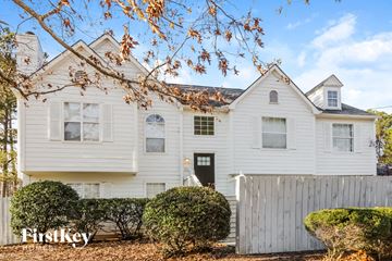Dallas house for rent - a white house with a white fence and shrubs