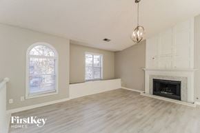 Dallas house for rent - an empty living room with a fireplace and a window